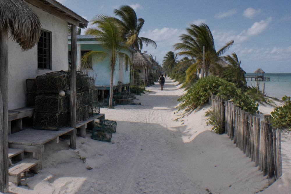 Fishing village houses along a sandy spit between lagoon and sea