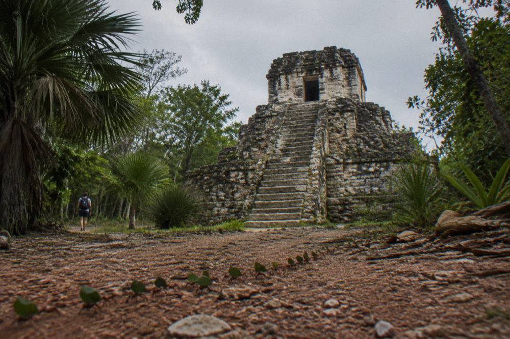 Tall stone pyramid rising above dense green jungle