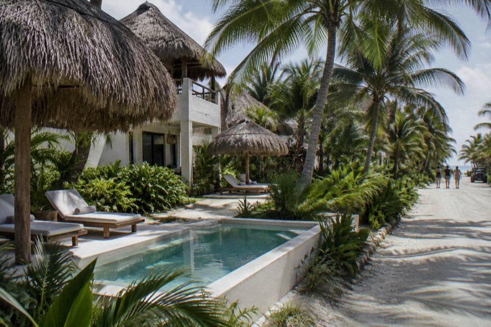 Boutique Hotel With Palapa Roofs And A Pool In A Jungle Garden